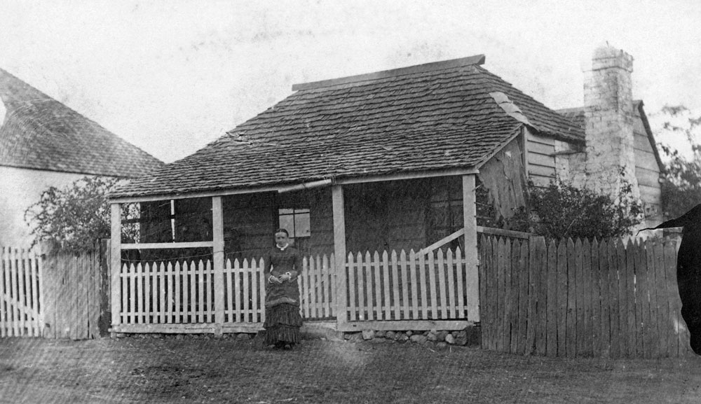 Unidentified woman in front of house at Walloon, Ipswich, early 1880s