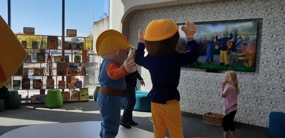 Bob the Builder and Fireman Sam playing with the interactive Butterfly screen at Ipswich Children's Library, Ipswich, 2021