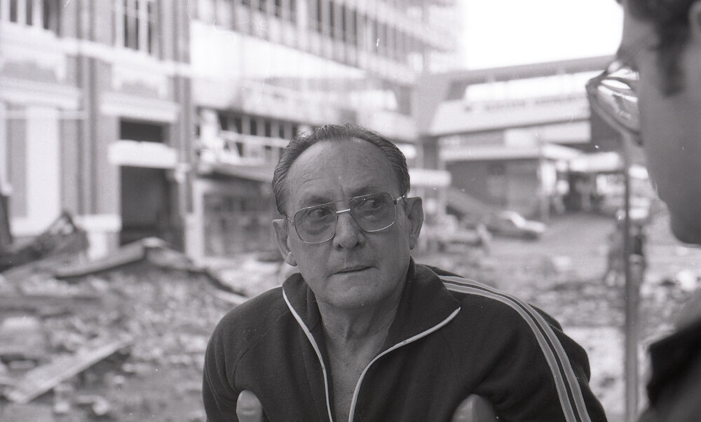 Man viewing the aftermath of the Reid's (Cribb &amp; Foote) fire, Bell Street, Ipswich, August 1985