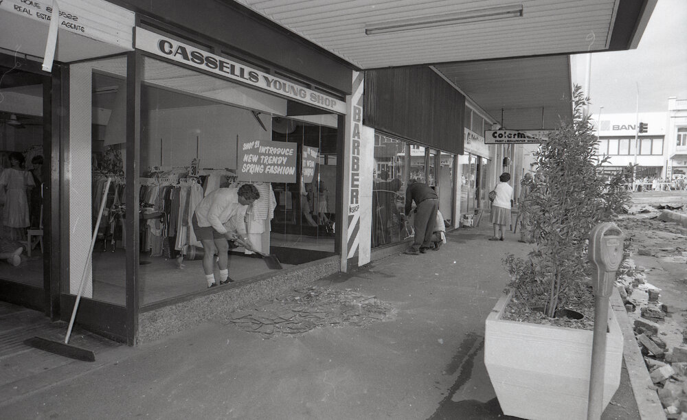 Cleaning-up broken glass from the shop window of Cassells clothing store, in the aftermath of the Reid's (Cribb &amp; Foote) fire, Bell Street, Ipswich, August 1985