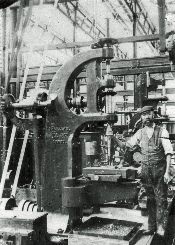 John Close Bleakley with drill machine at the Ipswich Railway Workshops, North Ipswich, early 1900s