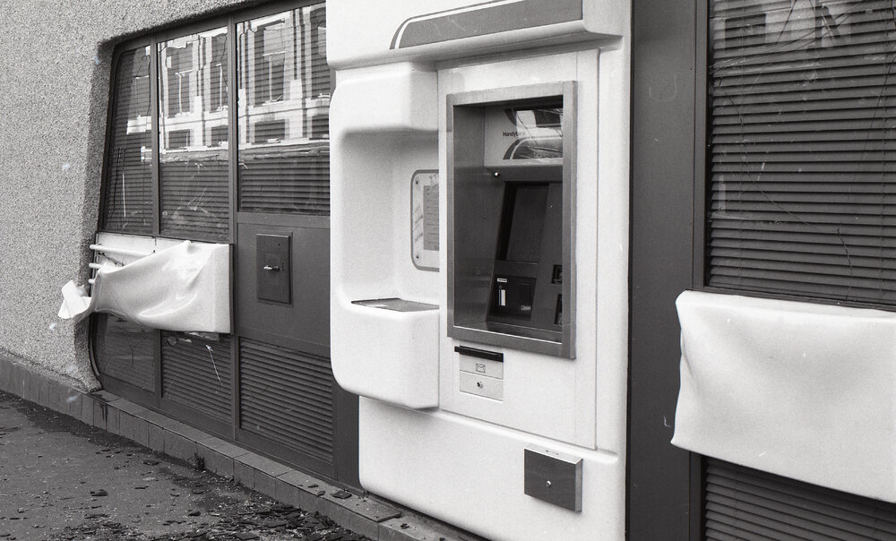 Damaged Automatic Teller Machine (ATM) at Westpac, in the aftermath of the Reid's (Cribb &amp; Foote) fire, Bell Street, Ipswich, August 1985