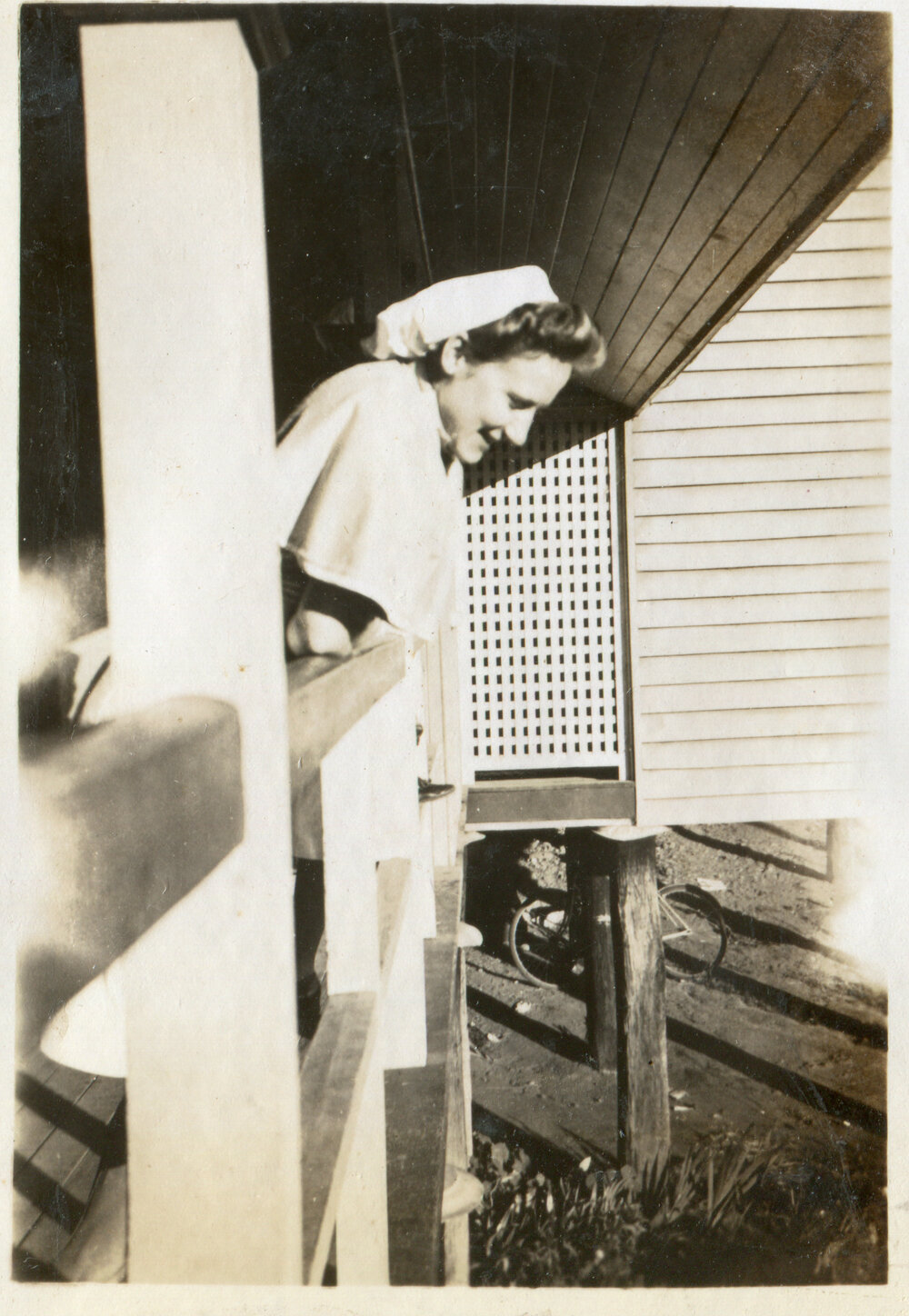 Nurse on verandah of wooden building, 1940s