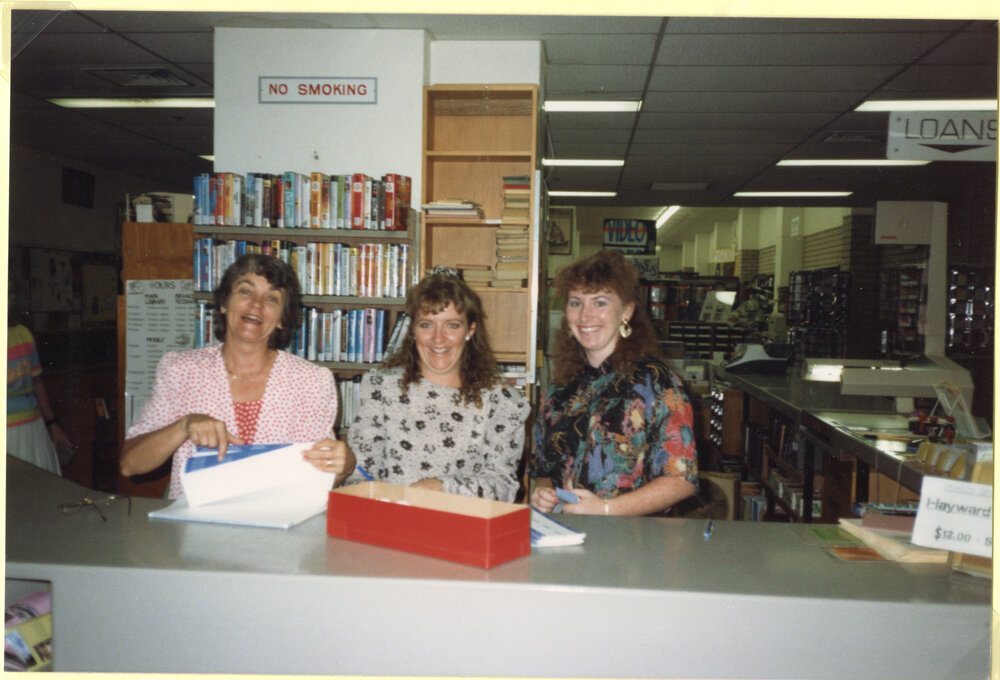 Staff standing behind the front counter, Ipswich Municipal Library, Ipswich Centre, Bell &amp; East Streets, Ipswich, 1989
