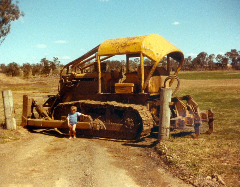 Bulldozer parked across entrance to construction site for Ipswich Softball Association grounds, Chubb Street, Leichhardt, Ipswich, 1985