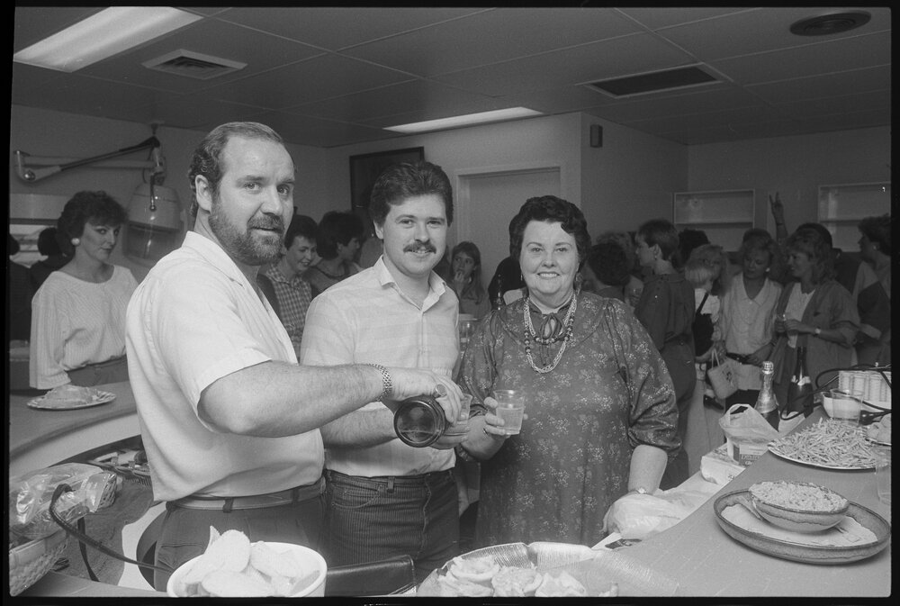Crowd of people having a party in an unidentified salon in Redbank Plaza Shopping Centre during construction, Redbank, September 1985