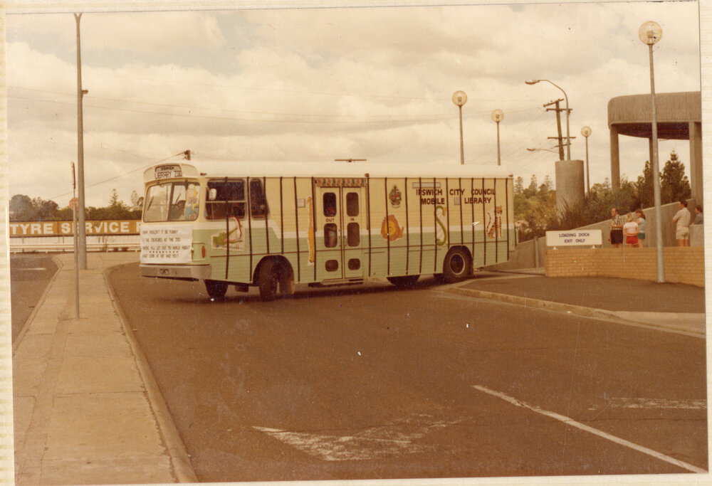 Bookmobile, decorated for a parade, exiting the library loading dock, onto Bell Street, Ipswich Municipal Library, Ipswich Centre, Bell &amp; East Streets, Ipswich, c.1980
