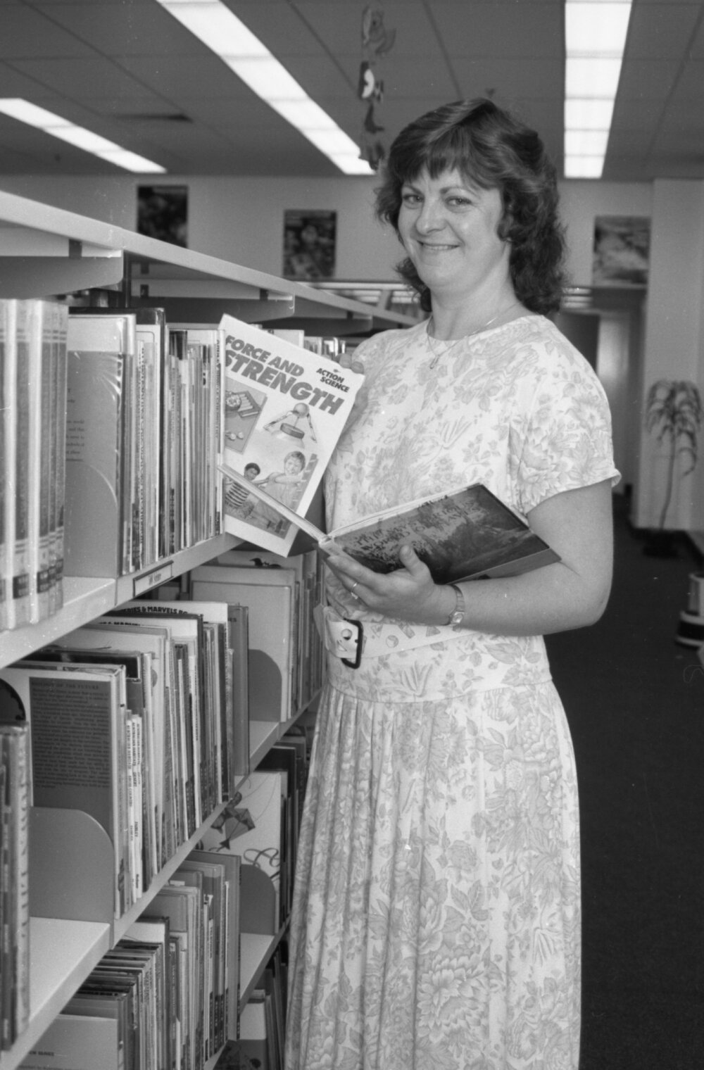 Unidentified staff member at Redbank Plaza Library shelving books, Redbank, September 1985