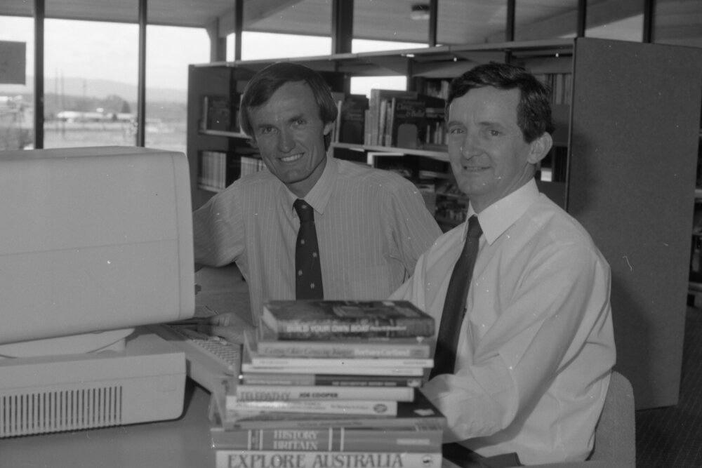 Moreton Shire Counsellor Neil William Russell and unidentified man using the computer at Redbank Plains Library, Redbank Plains, September 1985
