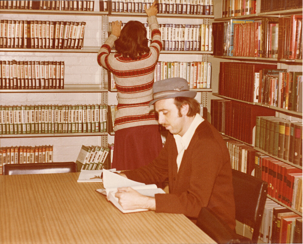 Carol Masters tidying shelves in the large print section, Ipswich Municipal Library, corner of Nicholas and Limestone Streets, Ipswich, 1970s
