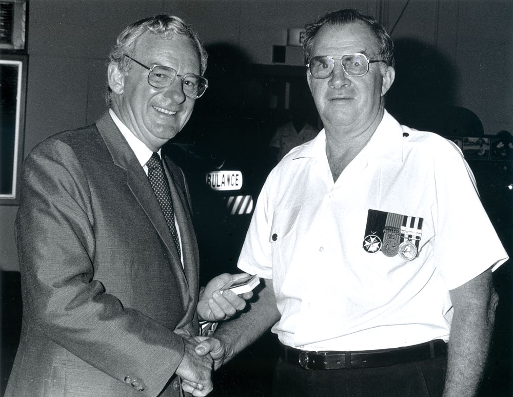 Bill Hayden presenting 15 year Long Service Medal to Dick Fairhurst, ambulance officer, North Ipswich, c.1985