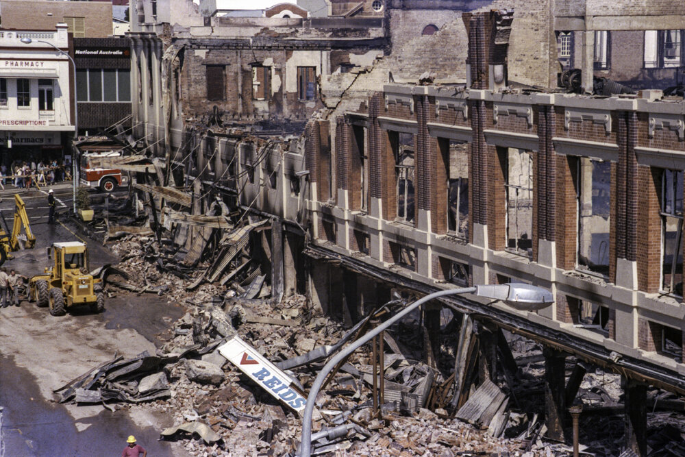 Series of images depicting the aftermath of the Reid's (Cribb &amp; Foote) Fire, Brisbane and Bell Streets, Ipswich, August 1985