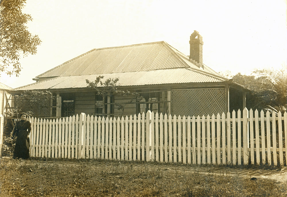 Unidentified woman in front of what is thought to be a Noble family home at Walloon, Ipswich, before 1900