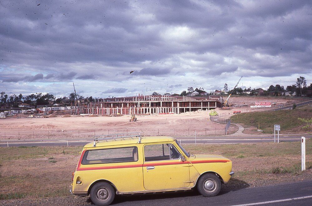 Yellow car in front of Redbank Plaza during construction, Redbank, Ipswich, c.1985