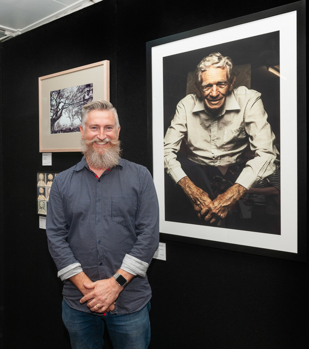 Jason McNamara with his portrait of former Ipswich Mayor John Nugent, Ipswich Art Awards, 2018