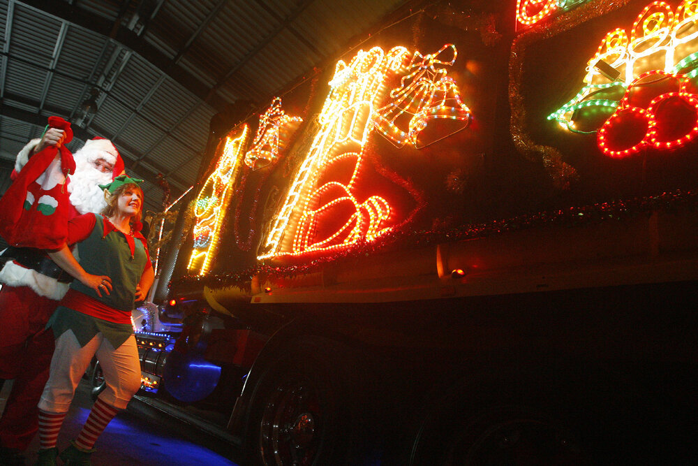 Santa, and his elf helper, with the decorated Sapar truck, Ipswich, December 2010