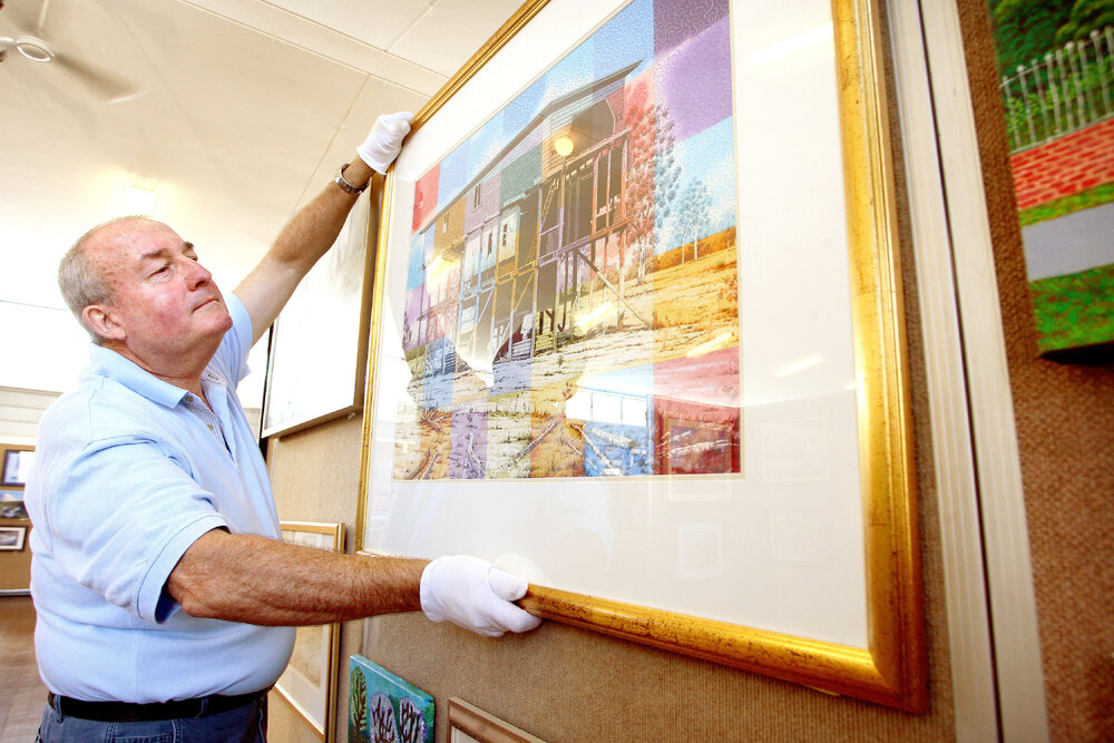 Wayne McDonnell hanging artworks for the Ipswich Art Awards, April 2007