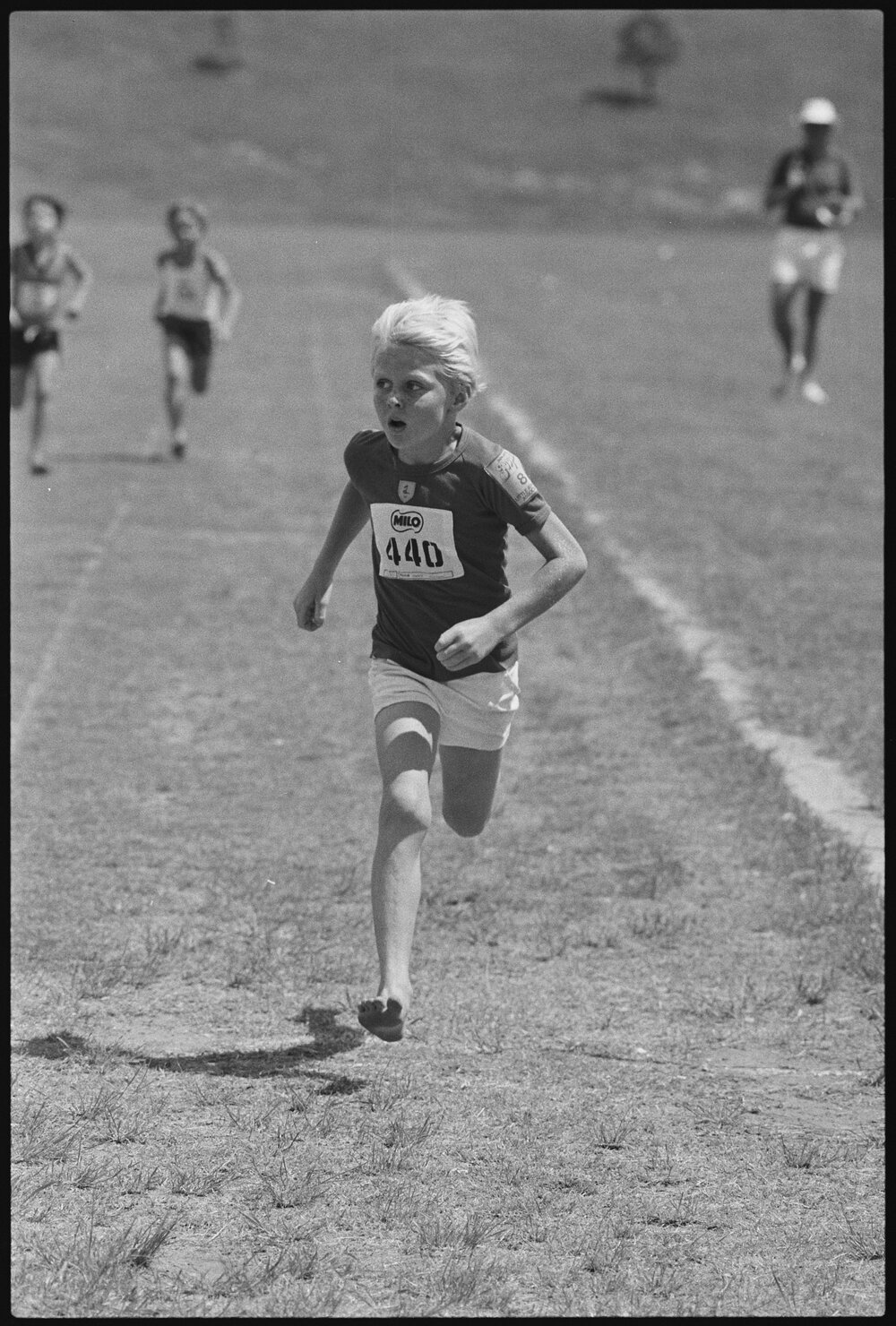 Unidentified Little Athletics Association event participant running, Ipswich, January 1986