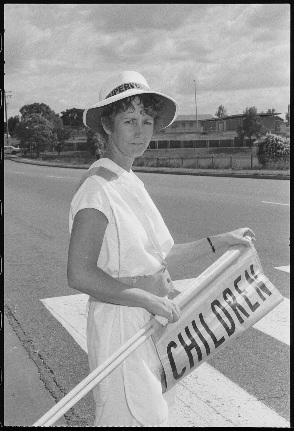Unidentified lolly pop lady, first day of school, Ipswich, January 1986