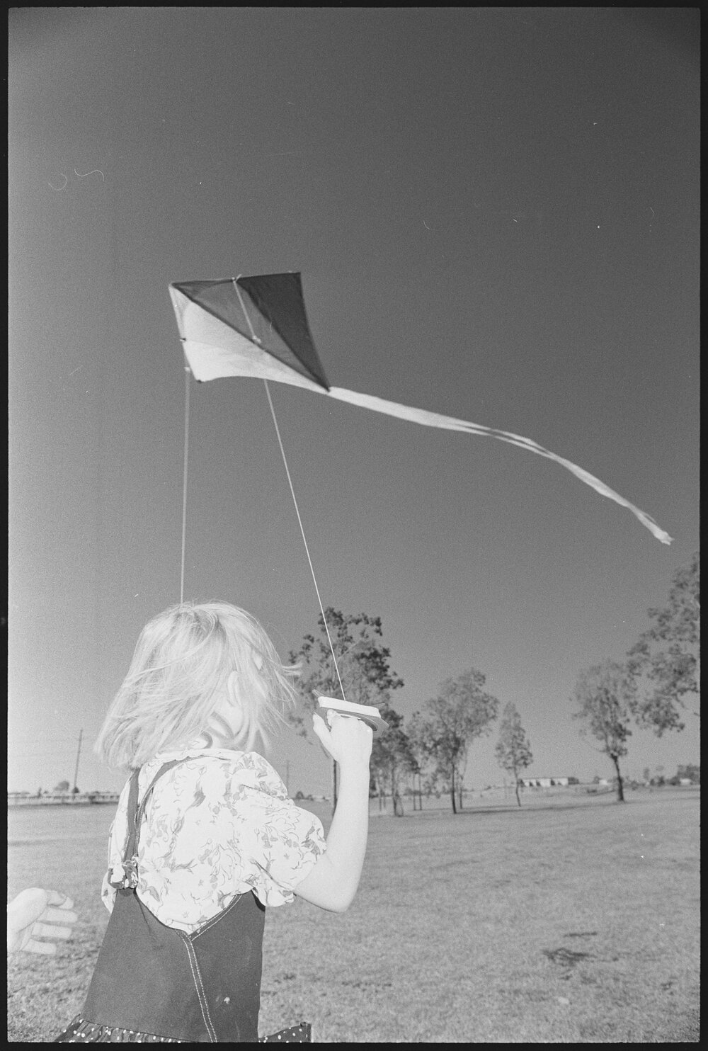 Unidentified girl flying kite, Ipswich region, 1st August 1994