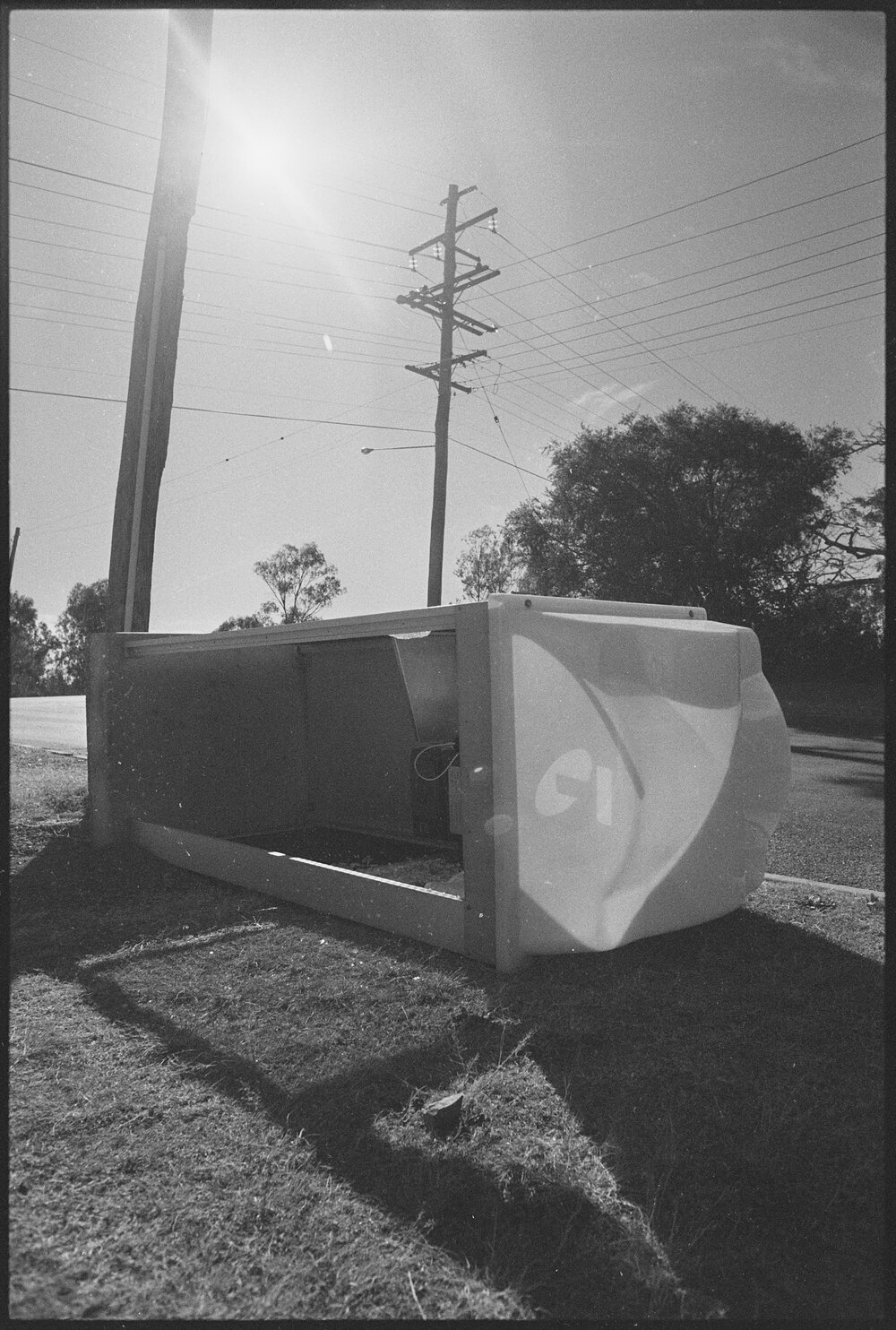 Vandalised Telstra public telephone booth, laying on its side, corner Briggs and Salisbury Road, Ipswich, 1st August 1994