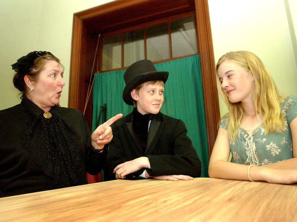 Susan Glosko as "Mrs Sowerberry", Ryan Richards as "Noah Claypole" and Justine Muller as "Charlotte Sowerberry" as part of the cast in the Oliver Musical, Ipswich, August 2004 