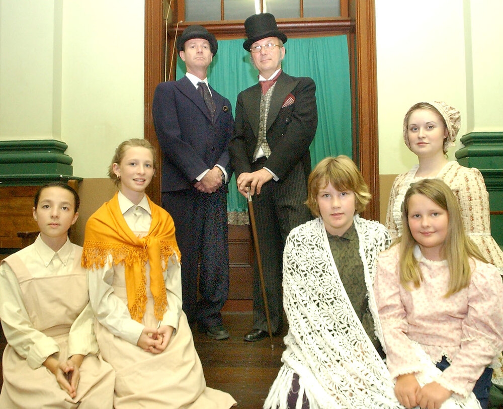 Otis Ogg as "Dr Grimwig", Bob Polowyj as "Mr Brownlow", and Ruby Farley, Jemma Farley, Danica Muller, Nardine Ledger, and Rebecca Noble as part of the cast in the Oliver Musical, Ipswich, August 2004 