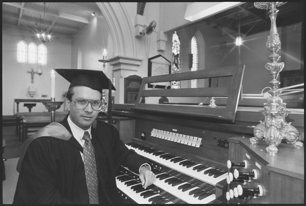 Unidentified organist in academic cap and gown, at St Paul's Anglican Church, Ipswich, August 1994