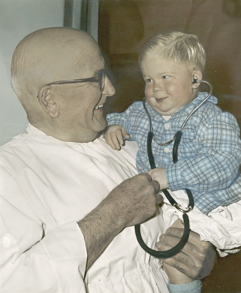 Dr David Ernest Trumpy, Medical Superintendent, Ipswich General Hospital, with young patient, Ipswich, 1960