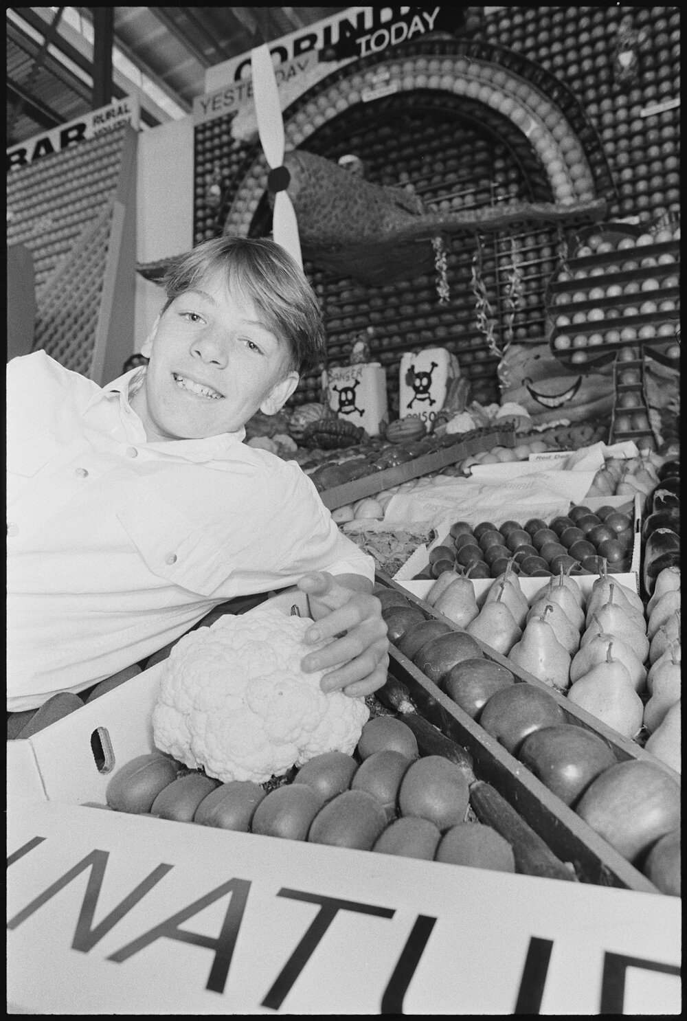 Unidentified boy with fruit display, Royal Queensland Show (Ekka), Brisbane Showgrounds, 18th August 1994