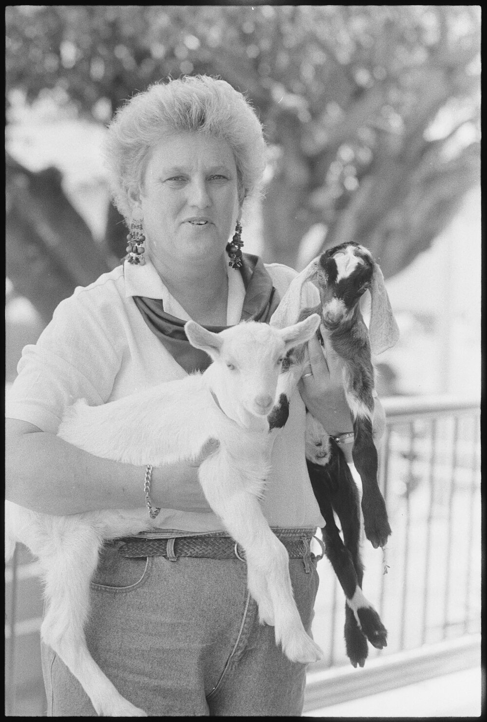 Unidentified woman with baby goats at the Ekka, Brisbane Showgrounds, Brisbane, 20th August 1994