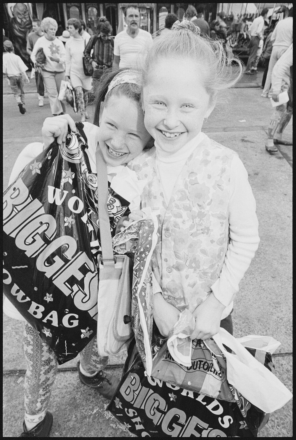 Two unidentified girls with show bags at the Ekka, Brisbane Showgrounds, Brisbane, 21st August 1994