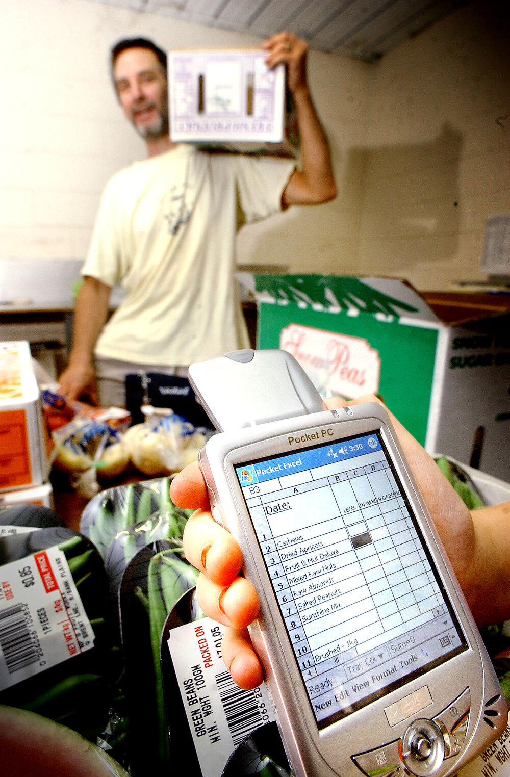 Paul Mitchell finds his new portable Pocket PC very useful for his small buisness NP's Fruit Workx, Ipswich, 17th January 2005 