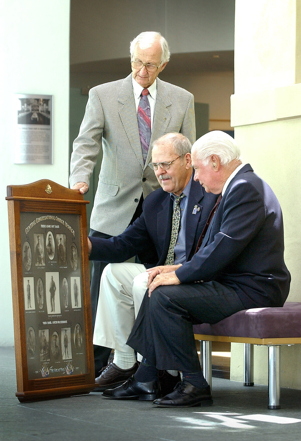 Image donor John Whitehead, Vice-President of Ipswich RSL Eddie Habben and donator of the frame Les Miller with the collection of images of WW1 soldiers who didn't return, Ipswich, 14th February 2005