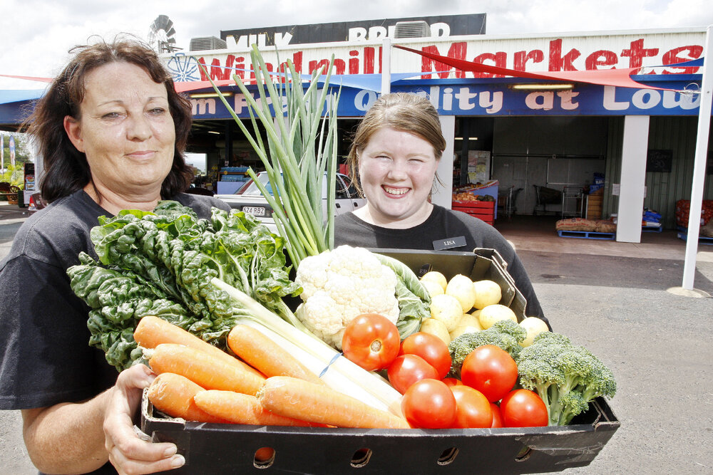 Employees of the Windmill Markets fruit shop on the Warrego Highway near Gatton, Trish Maycock and Lisa Beasley, preparing for the price increase to fruit and vegetables caused by the recent flood damage to Queensland crops, Ipswich, 4th January 2011