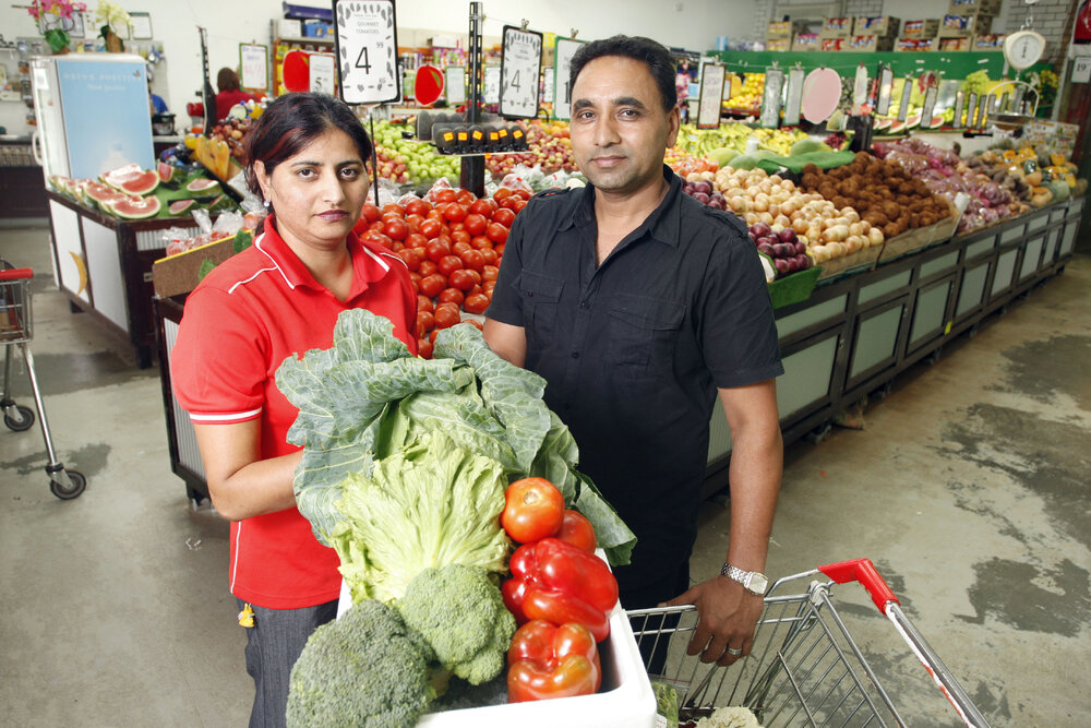 Devinder Singh with her brother in law Amarjit Singh at their family business Dinmore Fruit Barn where fruit and vegetable stocks are low and expensive because of the recent flooding, Ipswich, 6th January 2011