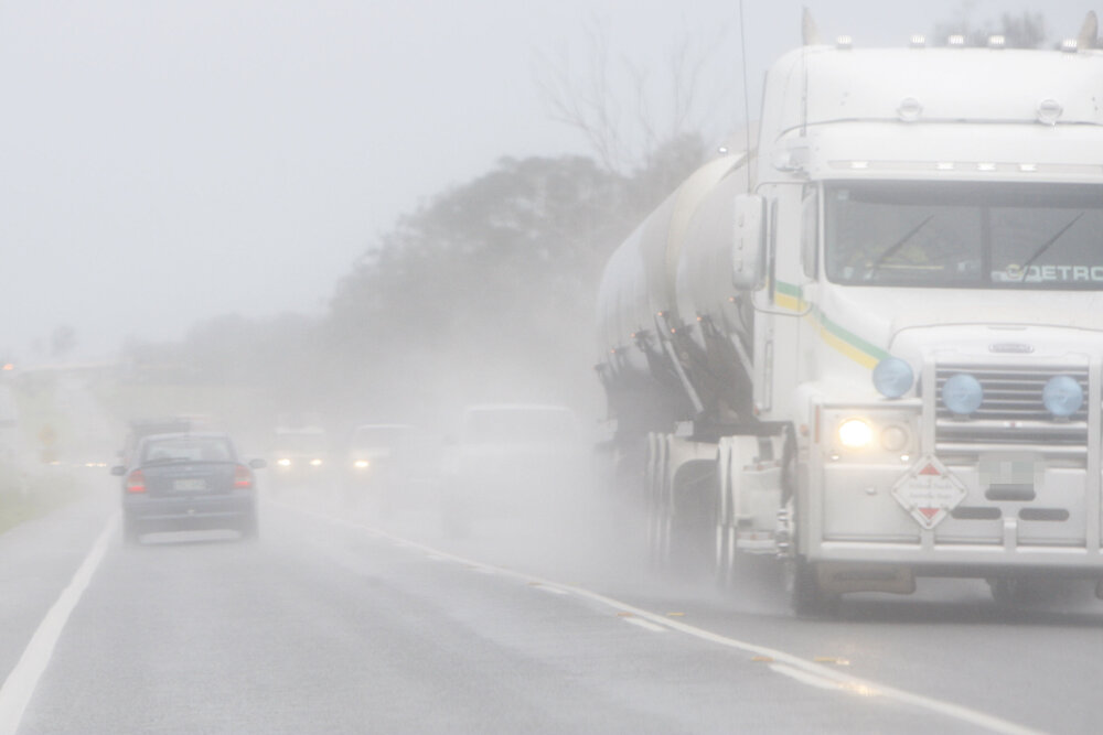 Cars and Trucks drive through wet weather along the Cunningham Highway at Amberley as the region experienced heavy rain again yesterday, Ipswich, 6th January 2011 