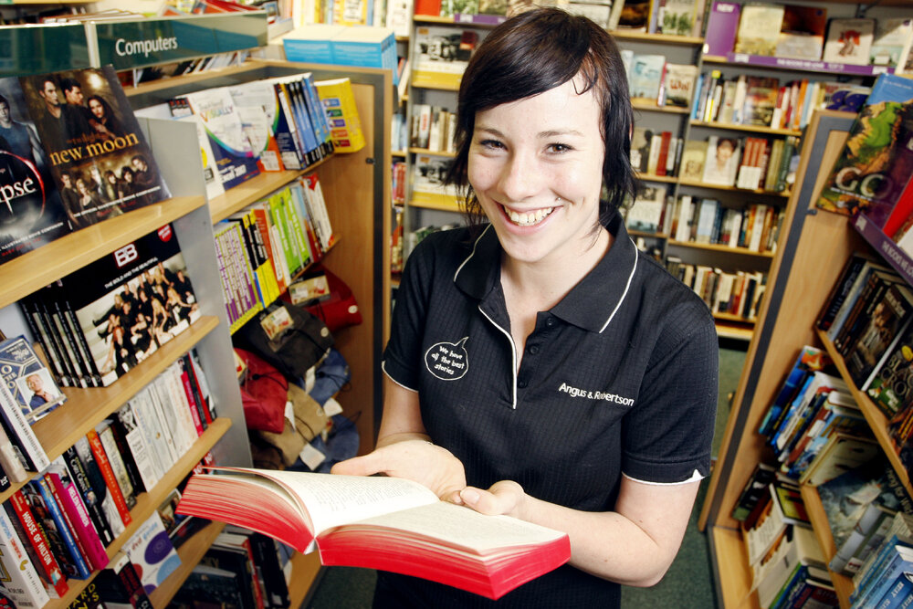Angus and Robertson shop assistant Kate Denman with a Twilight and Harry Potter book. Both series have been listed as a couple of Ipswich's favourite books, Ipswich, 10th January 2011 