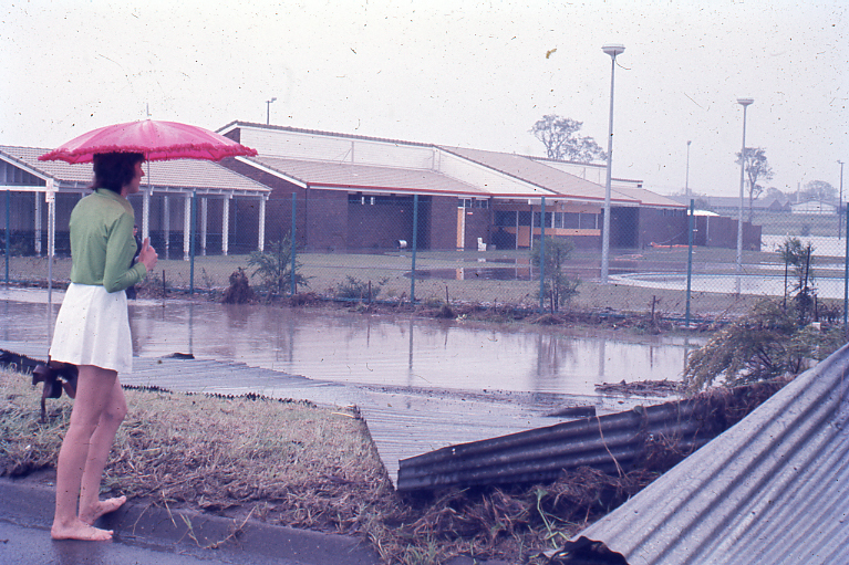 Bundamba Swimming Pool and demolished Racecourse fence at 12:30pm, Ipswich, 26th January 1974