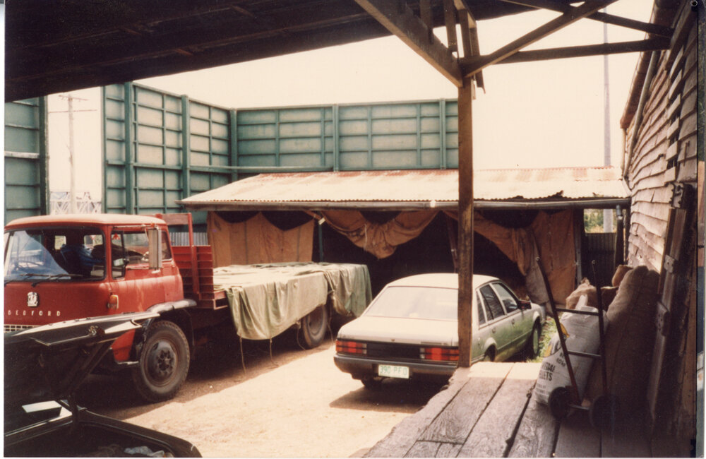 Car and Truck parked at Risson's Produce