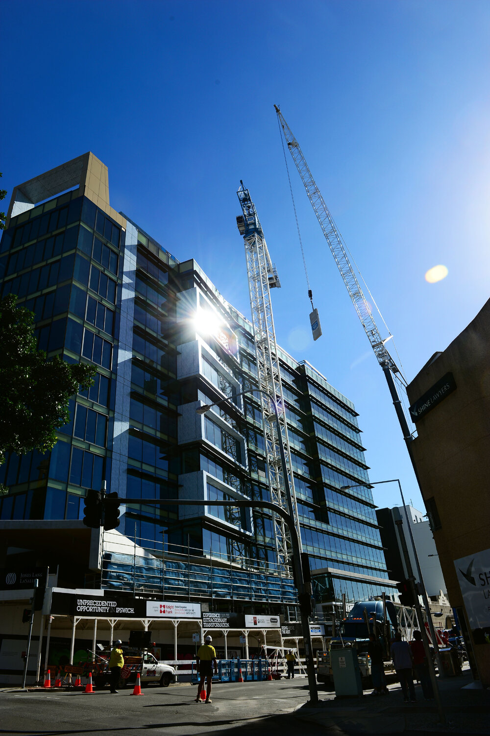 A large mobile crane dismantles the crane used to build Icon Ipswich marking the buildings completion, Ipswich, 25 May 2013