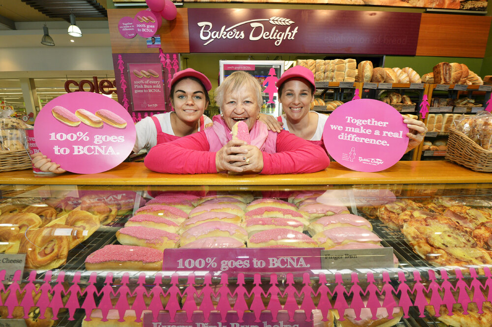 Colleen Julian from Ipswich Breast Cancer Support Group is promoting Baker's Delight pink buns with Kirsten Hutchison and Allison van Der Merwe from Baker's Delight to raise money for Breast Cancer Network Australia, Ipswich, 16 May 2013