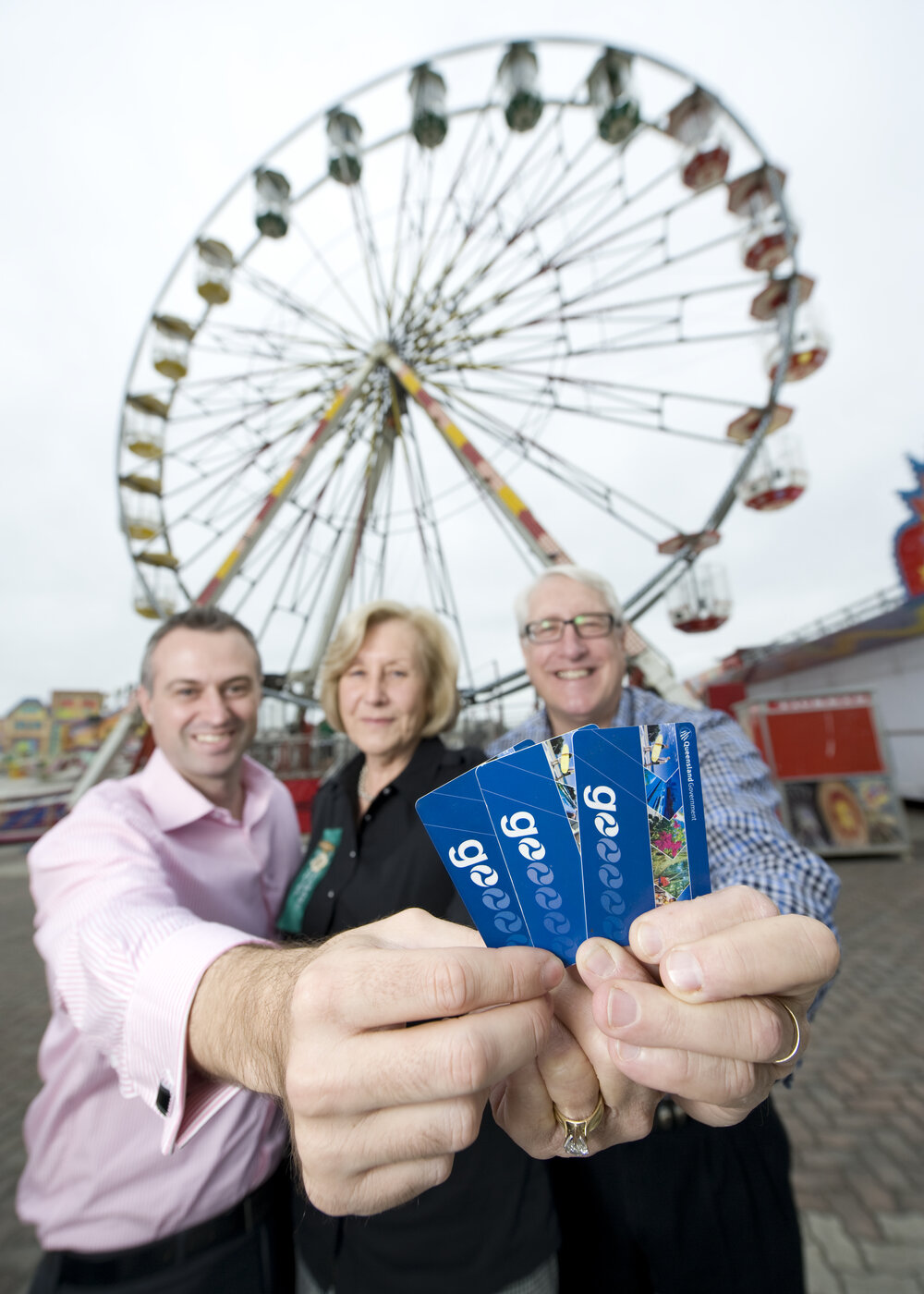 Westside Bus Company general manager Mark Thatcher, Ipswich Show Society president Marcia Cruickshank and Ipswich MP Ian Berry sit in the Ipswich Show ferries wheel with Go Cards, Ipswich, 16 May 2013