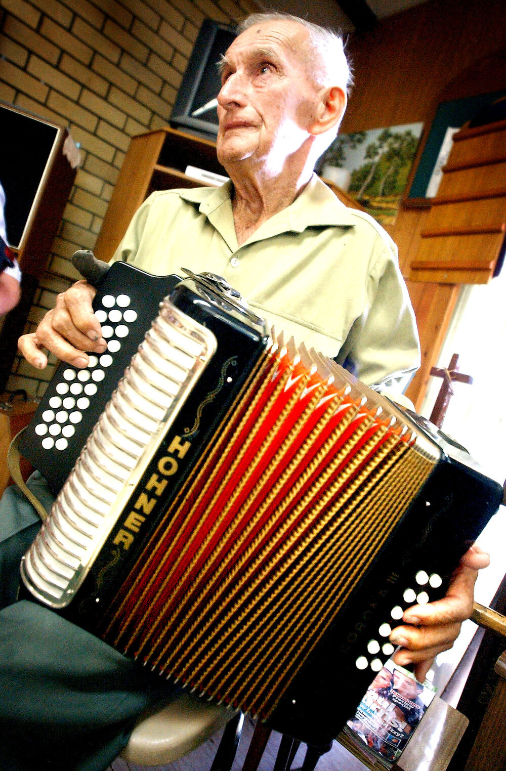 Ron Kerle (aged 84) plays the button accordion for the residents of Lauriston nursing home, Ipswich, 3 February 2005 