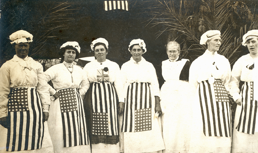 Thought to be members of the Ipswich Booval Soldiers' Comfort Club, wearing American flag aprons, Booval, Ipswich, 1916-1917
