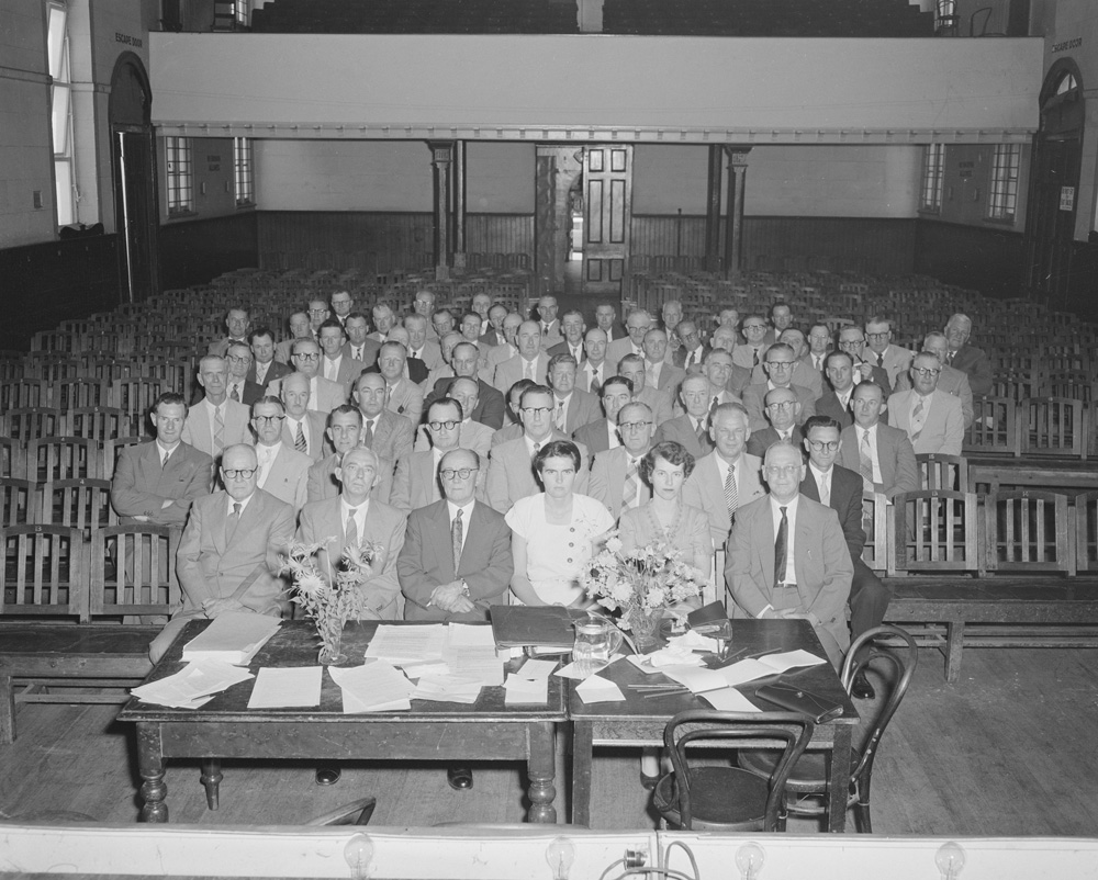 Group of people seated at a meeting in Town Hall, Brisbane Street, Ipswich, 1958
