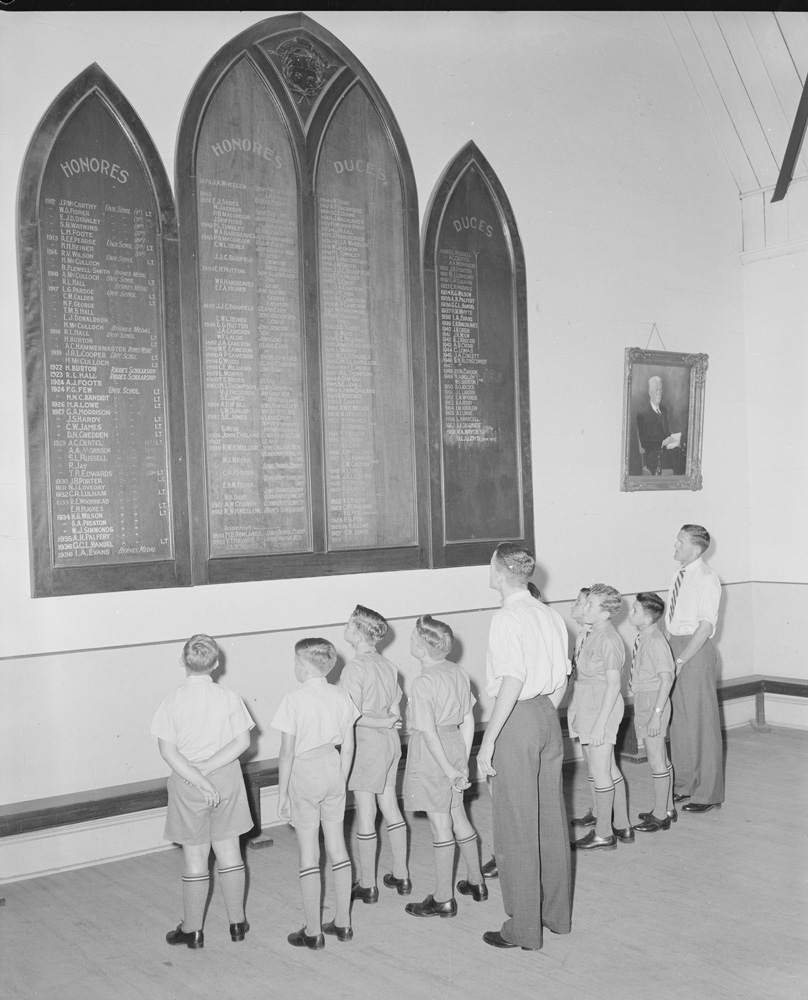 Ipswich Grammar School students looking at honour board, Great Hall, Ipswich Grammar School, Ipswich, 1959