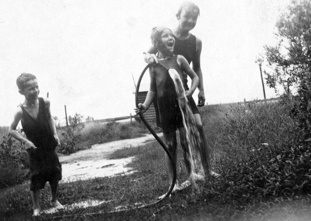 Backyard fun with the hose, Ipswich, mid 1920s