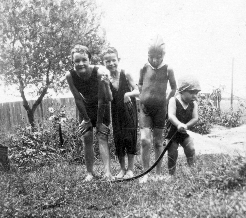 Playing with a hose, Ipswich, mid 1920s
