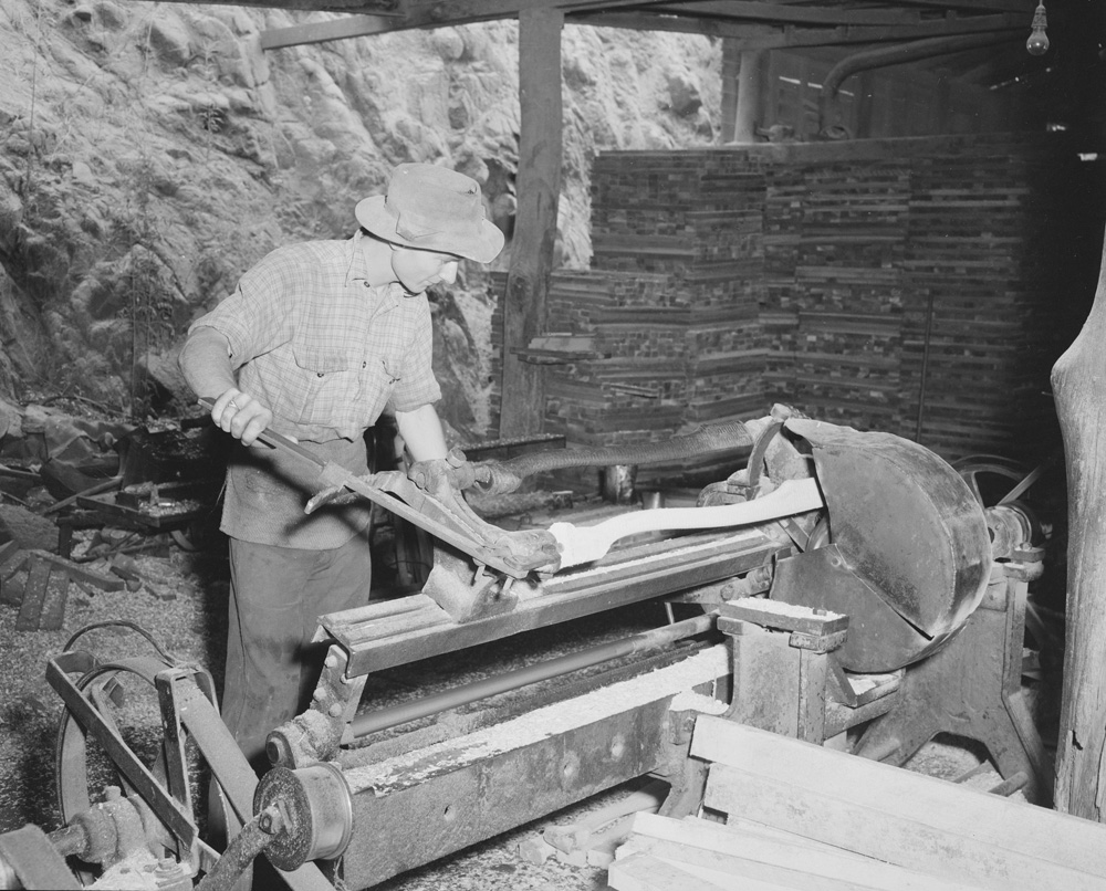 Worker using a lathe at Kruger Sawmill, Byrne Street, Bundamba, Ipswich, 1959